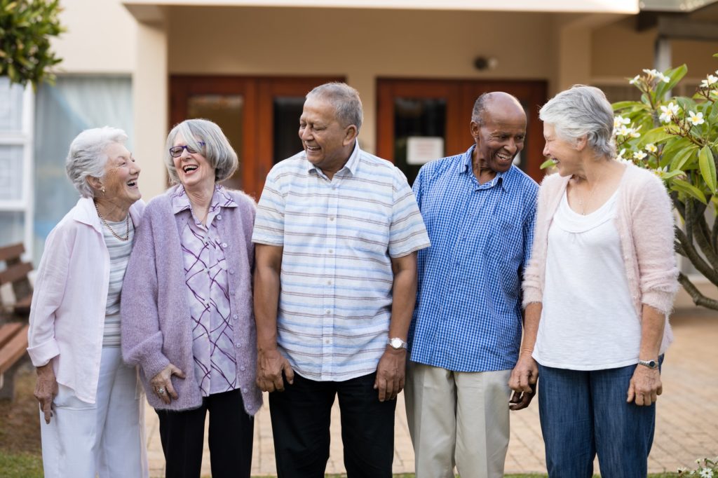 Cheerful senior men and women at nursing home